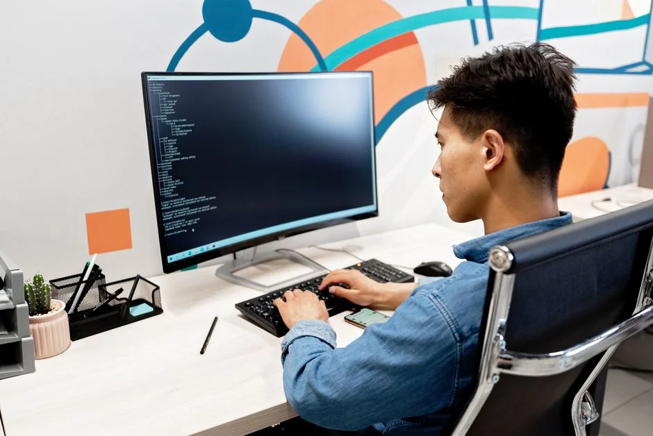 A modern computer screen displaying web design work, showcasing creative visuals in a workspace.